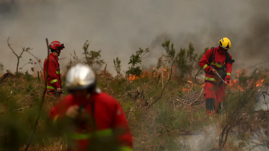 Firefighters survey a wildfire scene amid heavy smoke near Bordeaux, France, on July 26, 2026. Image Credit: Getty Images.
